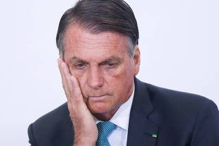 Brazil's President Jair Bolsonaro reacts during a ceremony at the Planalto Palace, in Brasilia
