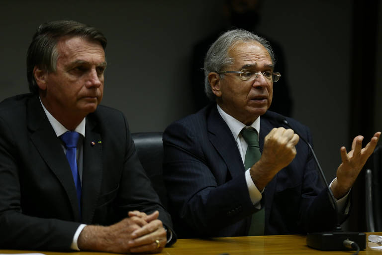 O presidente Jair Bolsonaro sentado ao lado do ministro da Economia, Paulo Guedes, durante coletiva de imprensa