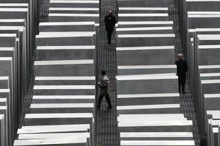 Visitors walk between the concrete pillars at the new Holocaust memorial in Berlin