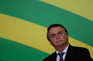 Brazil's President Jair Bolsonaro looks on during the ceremony to consolidate the Infralegal Labor Regulatory Framework, in Brasilia