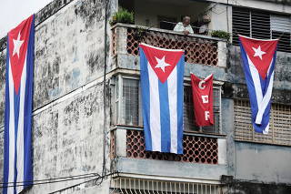 Cuban flags cover the windows of the house of actor, playwright and leader of the Facebook group called Archipelago Yunior Garcia, in Havana