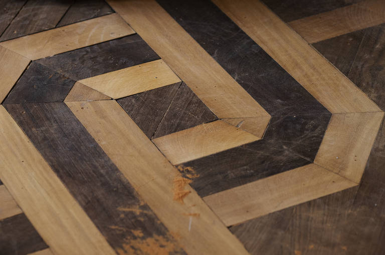 detalhe do desenho formado pelos tacos de madeira no piso do museu, em que madeiras escuras contrastam com madeiras claras, entrelaçadas de forma circular 