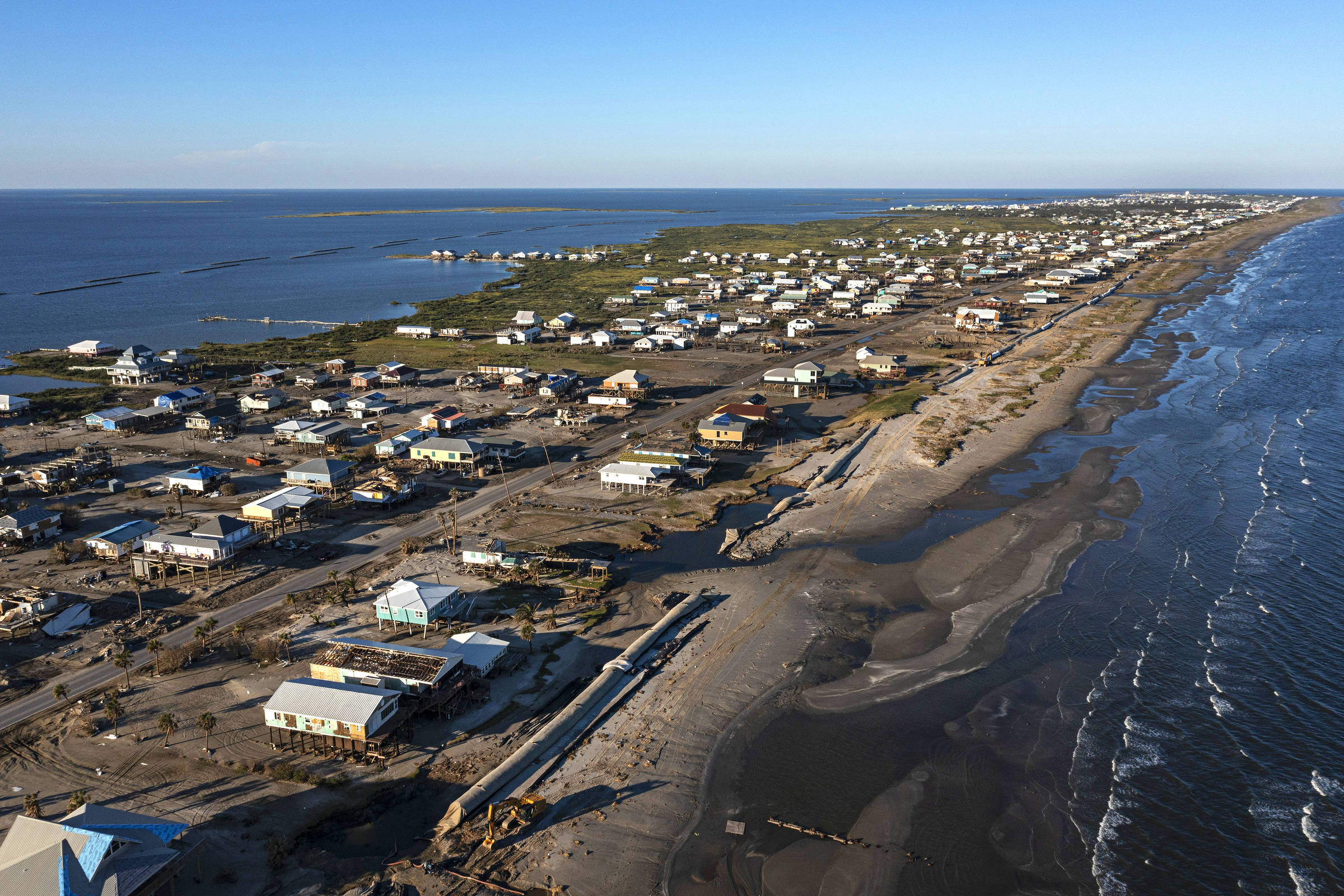 Protection dam, nicknamed 'burrito,' in front of houses on Grand Isle beach, after Hurricane Ida