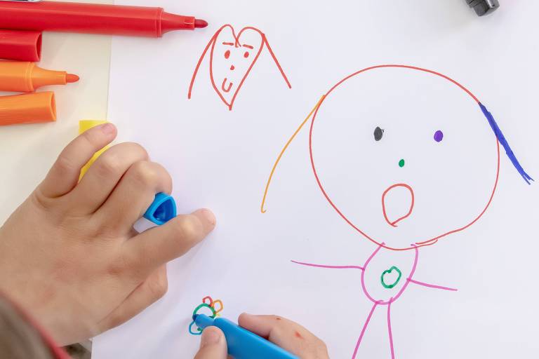 Folha com desenho de uma criança com traços coloridos mostra a figura de uma pessoa com braços abertos 