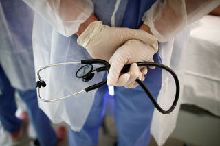 FILE PHOTO: A doctor holds a stethoscope in the Intensive Care Unit (ICU) at the Melun-Senart hospital, near Paris