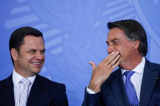 Brazil's Justice Minister Anderson Torres talks with Brazil's President Jair Bolsonaro during a ceremony at the Planalto Palace