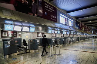 International check-in counters stand empty as several airlines stopped flying out of South Africa, amidst the spread of the new SARS-CoV-2 variant Omicron, at O.R. Tambo International Airport, in Johannesburg
