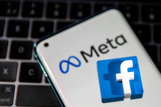 FILE PHOTO: A smartphone with Meta logo and a 3D printed Facebook logo is placed on a laptop keyboard in this illustration