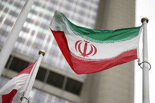 FILE PHOTO: The Iranian flag flies in front of the U.N. nuclear watchdog (IAEA) headquarters in Vienna, Austria