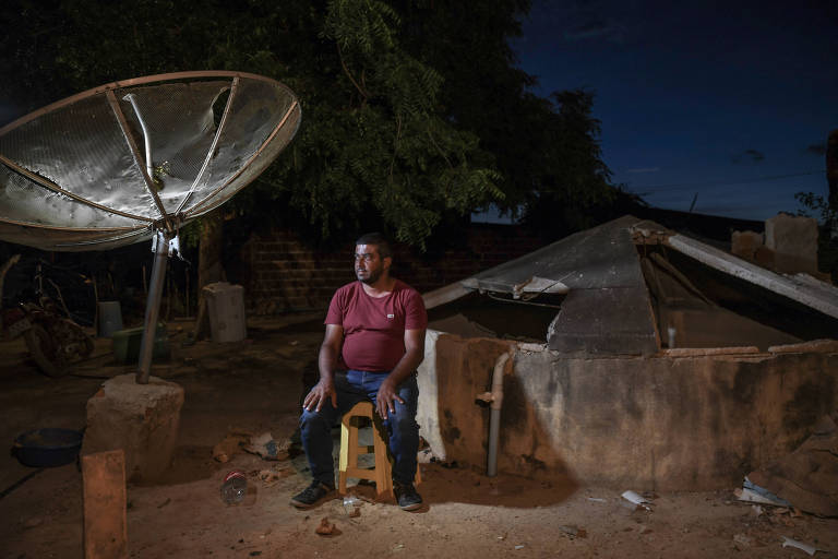 Sentado, o agricultor Lucivaldo Elizeu Barbosa, 40, ao lado de cisterna danificada que não retém água, em seu sítio na zona rural de Petrolina (PE)