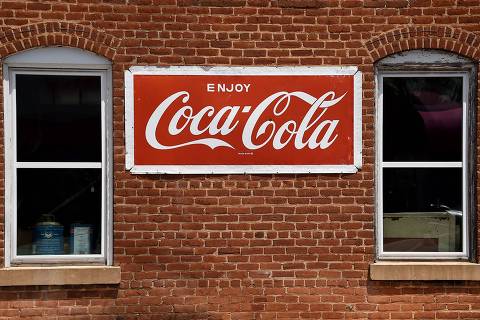 (FILES) In this file photo taken on May 09, 2020, Coca Cola sign at a store in Amherst, Virginia  on May 9, 2020. - While the pandemic recovery remains uneven, Coca-Cola said on October 27, 2021, it expects improved earnings for the year as soft drink consumption improves worldwide, aided by reopening businesses. The iconic soda brand saw 