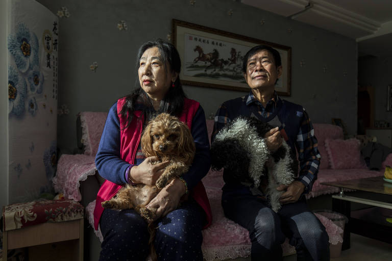 Hu Lingfang, left, and Wang Jinzhong at their home in Baoding, China, on Nov. 22, 2021. Their son Wang Yinpeng, 37, is serving a life sentence for buying, collecting and trading toy guns. (Qilai Shen/The New York Times)