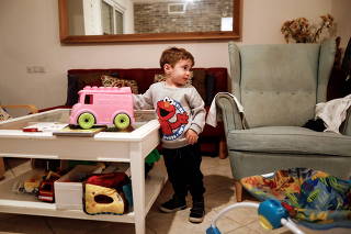 Eran, a 3-year-old Israeli boy who suffered from PIMS, a rare consequence of COVID-19, plays with a toy truck in Tzur Hadassah
