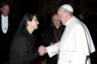 Italian nun Sister Raffaella Petrini, who is the first woman to be appointed as the number two position in the governorship of Vatican City, is greeted by Pope Francis in this undated handout photo