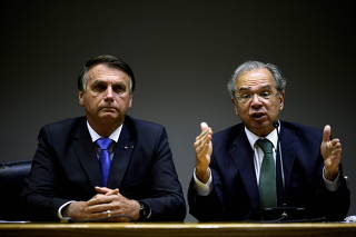FILE PHOTO: Brazil's President Bolsonaro and Economy Minister Guedes attend a news conference in Brasilia