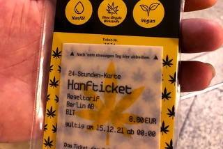 A person holds one of a few thousand limited BVG edible cannabis rice paper train tickets in Berlin