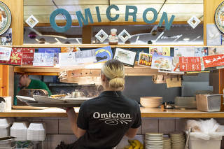 A server at Omicron Family Restaurant, in West Bend, Wis., Dec. 14, 2021. (Kevin Miyazaki/The New York Times)