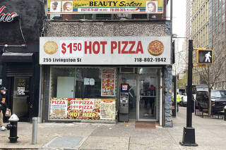 A new price on the facade of 99 Cents Pizza of Utica, which plans to rebrand as ?$1.50 Pizza of Utica? in Brooklyn, December 2021. (Jeanna Smialek/The New York Times)