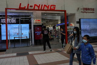 People walk past a store of Chinese sports products brand Li Ning in Beijing