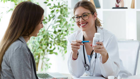 Shot of female dietician prescribing nutritional supplement for patient in the consultation.