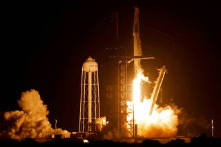 FILE PHOTO: SpaceX Falcon 9 rocket, with the Crew Dragon capsule, is launched carrying four astronauts on a mission to the International Space Station