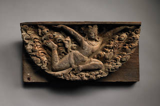 An undated photo provided by the Rubin Museum of Art of a 14th-century carving of a garland-bearing apsara, or spirit, that was originally part of an ornamental window in a Kathmandu monastery. (Rubin Museum of Art via The New York Times)