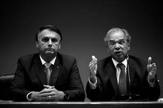 FILE PHOTO: Brazil's President Bolsonaro and Economy Minister Guedes attend a news conference in Brasilia