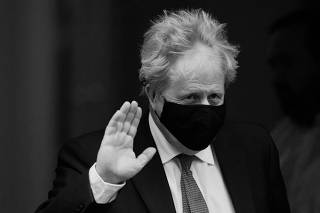 British PM Johnson walks outside Downing Street, in London