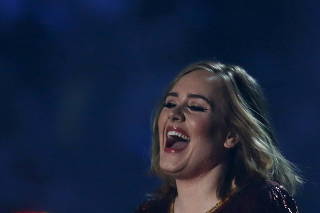 FILE PHOTO: British singer Adele receives her award for British Album of the Year at the BRIT Awards at the O2 arena in London, Britain