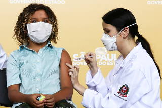 Children receive a dose of the COVID-19 vaccine in Sao Paulo