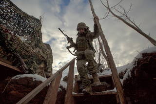 FILE PHOTO: A service member of the Ukrainian armed forces walks at combat positions in the Donetsk region
