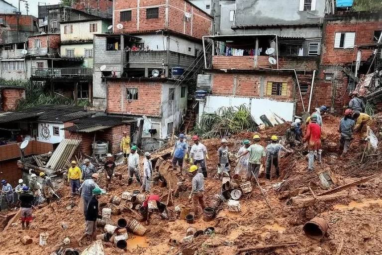 Imagem panorâmica mostra um grupo de voluntários e bombeiros procuram vítimas em escombros de deslizamento em Franco da Rocha
