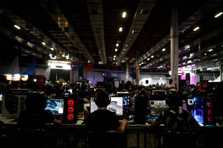 Men play on their computers during the Campus Party, internet users gathering, in Sao Paulo