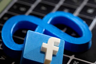 FILE PHOTO: A 3D-printed logo of Facebook sits atop logo of Facebook parent Meta in this photo illustration