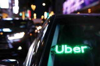 An unauthorised device displays a version of the Uber logo on a vehicle in Manhattan, New York City