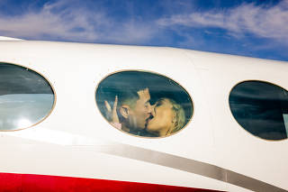 Brandon Nguyen kisses his wife Katherin before their takeoff on a Love Cloud flight to celebrate her birthday, at at North Las Vegas Airport in Las Vegas, Jan. 15, 2022. (Roger Kisby/The New York Times)