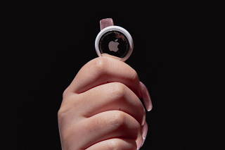 Ashley Estrada, who found an Apple AirTag that had been tracking her for four hours as she ran errands, holds up one of the devices, in Eastvale, Calif., Dec. 29, 2021. (Carlos Jaramillo/The New York Times)
