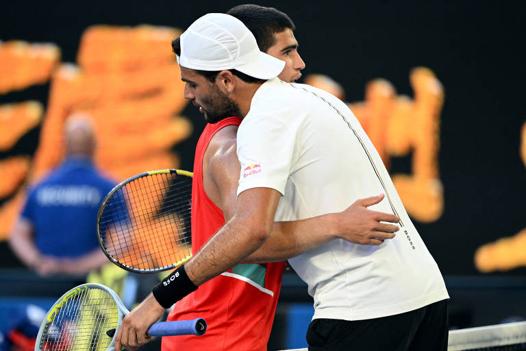 Os dois tenistas exauridos se abraçam junto à rede