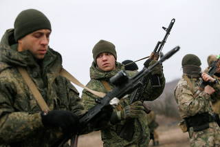 FILE PHOTO: Militants of the self-proclaimed Donetsk People's Republic train at a range in Donetsk