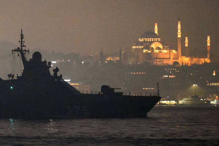 Navio de patrulha russo passa por Istambul rumo ao mar Negro, com a mesquita Süleymaniye ao fundo, uma semana antes da guerra
