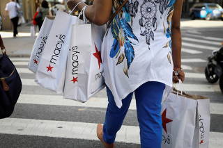 FILE PHOTO: FILE PHOTO: A woman carries shopping bags from Macy's department store in midtown Manhattan in New York