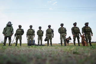 Soldiers stand during a start of a special operative as a measure to increase security and combat criminal groups at the border between Colombia and Venezuela, at a militar base in Arauca