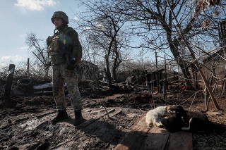 Ukrainian service member stands at a position on the front line near the village of Travneve
