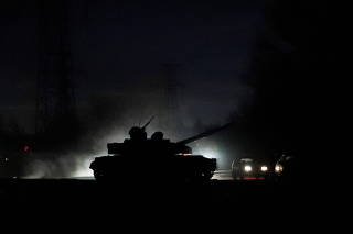 A tank drives along a street in Donetsk