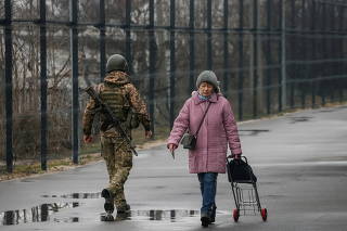 A woman crosses the contact line between Ukrainian troops and pro-Moscow rebels in the settlement of Stanytsia Luhanska