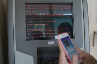 FILE PHOTO: A message demanding money is seen on a monitor of a payment terminal at a branch of Ukraine's state-owned bank Oschadbank after Ukrainian institutions were hit by a wave of cyber attacks earlier in the day, in Kiev