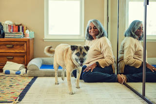 Darshna Shah and her dog Karl Malone, whose breakfasts include ashwagandha root and psyllium husk powder, at home in Cerritos, Calif., Feb. 3, 2022. (Ryan Young/The New York Times)