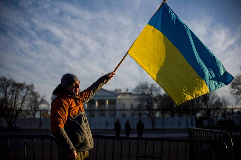 Manifestante segura bandeira da Ucrânia em protesto próximo à Casa Branca, em Washington, contra a invasão russa