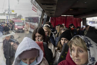 Ukrainian refugees leave Medyka, Poland on a bus to Przemysl after crossing the Ukrainian-Polish border, Feb. 25, 2022. (Maciek Nabrdalik/The New York Times)