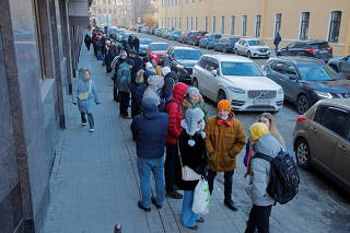 People stand in line to use an ATM money machine in Saint Petersburg
